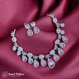 Necklace and earrings set on a burgundy fabric with 'Jewel Palace' branding.