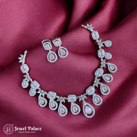 Necklace and earrings set on a burgundy fabric with 'Jewel Palace' branding.