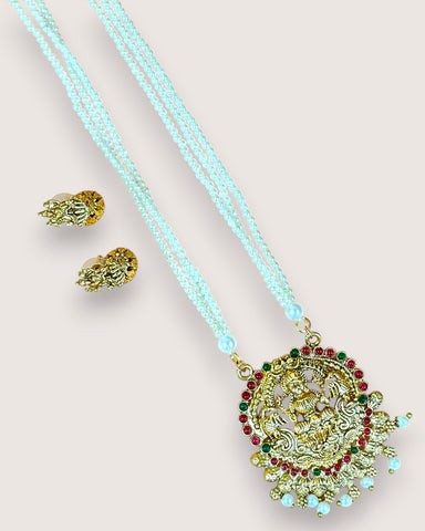 Necklace with pendant and matching earrings on a light background