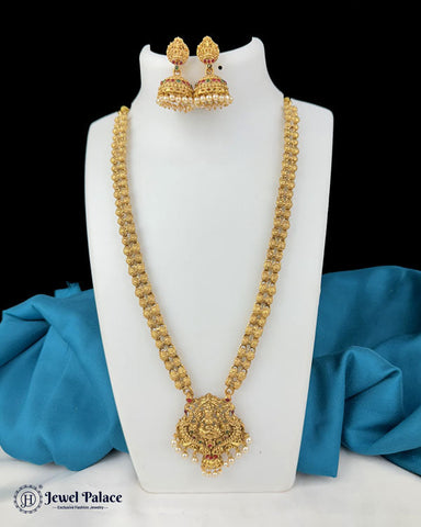 Gold necklace and earrings on a white stand with blue fabric in the background, brand 'Jewel Palace' visible.