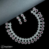 Necklace and earrings set with red gemstones on a black and gray gradient background, featuring the brand 'Jewel Palace'.
