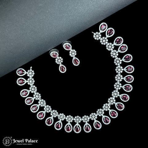 Necklace and earrings set with red gemstones on a black and gray gradient background, featuring the brand 'Jewel Palace'.