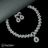 Necklace and earrings set with black stones on a black background, brand 'Jewel Palace' visible.