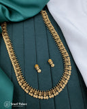 Gold necklace and earrings on a green fabric background with 'Jewel Palace' branding.