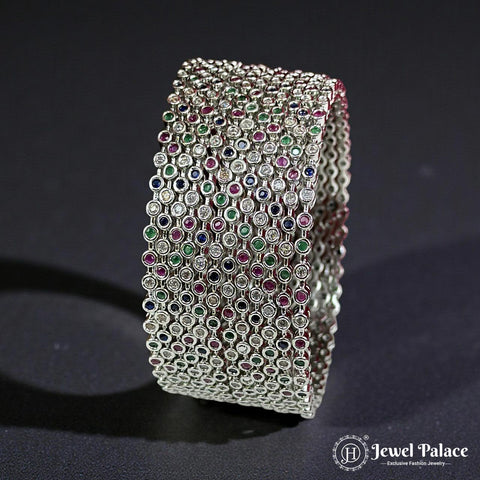 Silver bracelet with gemstones on a dark background, branded 'Jewel Palace'.