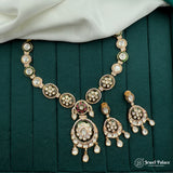 Ornate necklace with matching earrings on a green fabric background, brand 'Jewel Palace' visible.