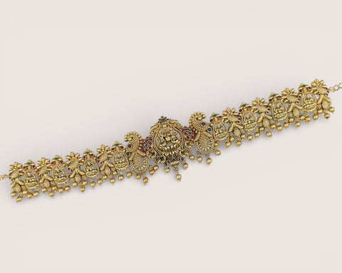 Decorative gold bracelet on a light gray background