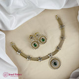 Gold necklace with green gemstones on a mannequin bust, brand 'Jewel Palace' visible.