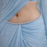 Light blue fabric with a decorative belt featuring pearls.