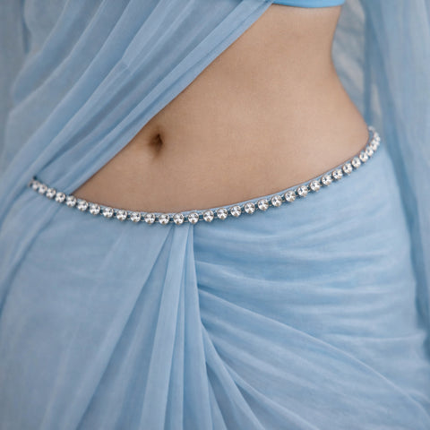 Light blue fabric with a decorative belt featuring pearls.