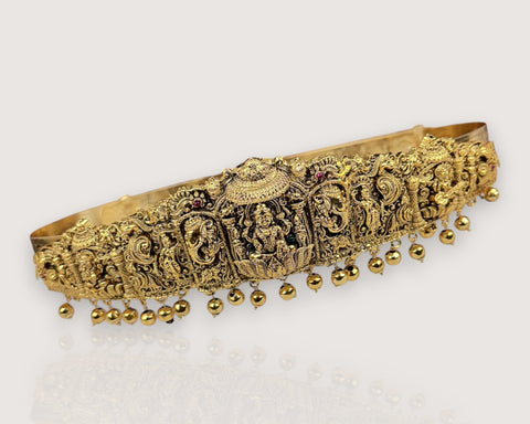 Decorative gold headband with intricate designs on a white background