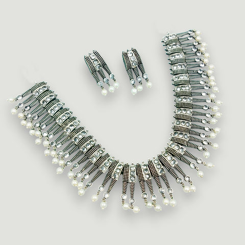 Jewelry set with necklace, bracelet, and earrings on a light gray background