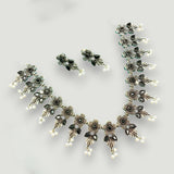 Ornate jewelry set with necklace, earrings, and ring on a light gray background