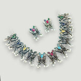 Jewelry set with necklace and earrings on a light gray background