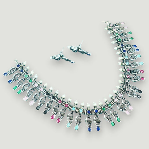Jewelry set with necklace and earrings on a light gray background