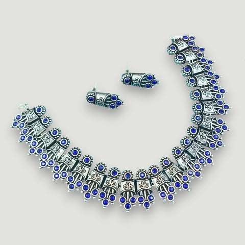 Jewelry set with necklace and earrings on a light gray background