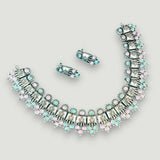 Jewelry set with necklace and earrings on a light gray background