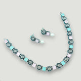 Jewelry set with necklace and earrings on a light gray background