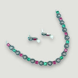 Necklace and earrings set with multicolored gemstones on a light gray background