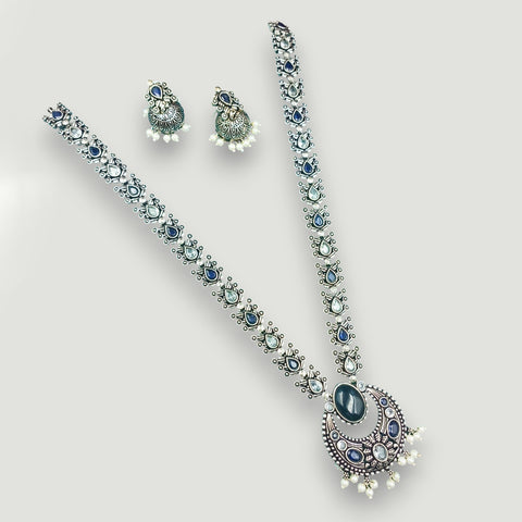 Jewelry set with necklace and earrings on a light gray background