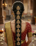 Woman with elaborate hair braid and traditional attire in a decorated indoor setting