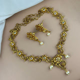 Gold necklace and earrings on a person's neck and chest.