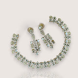 Jewelry set with necklace and earrings on a light pink background
