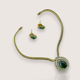 Jewelry set with necklace, bracelet, and earrings on a light gray background
