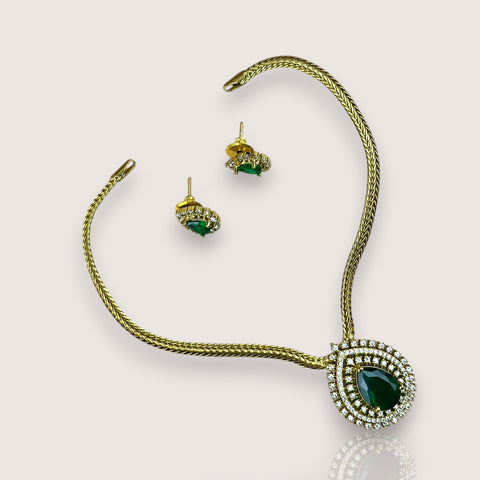 Jewelry set with necklace, bracelet, and earrings on a light gray background