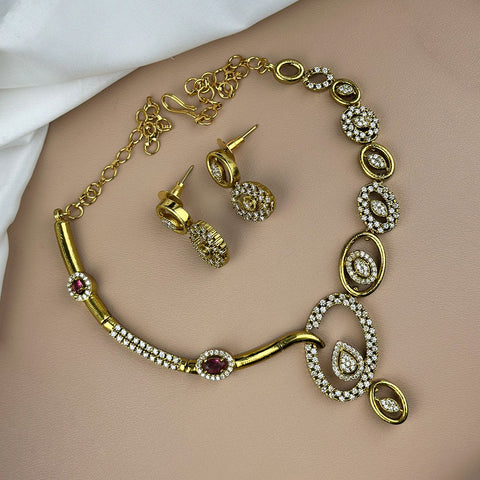 Gold necklace and earrings on a person's arm