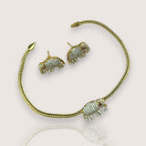 Gold elephant-shaped jewelry set on a light background