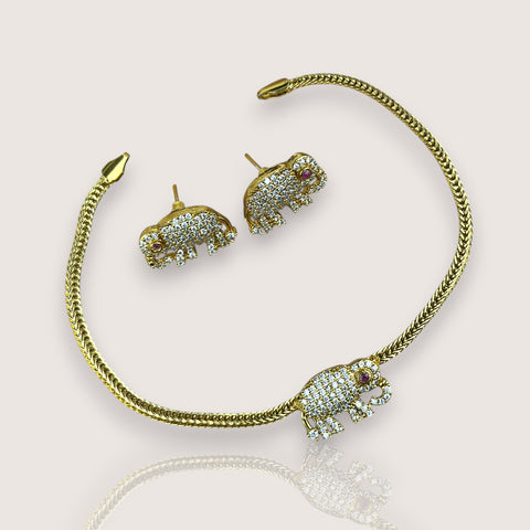 Gold elephant-shaped jewelry set on a light background
