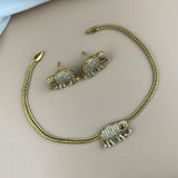 Gold elephant-shaped jewelry set on a light background