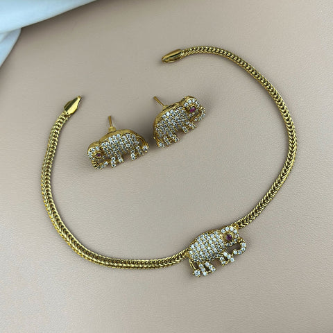 Gold elephant-shaped jewelry set on a light background
