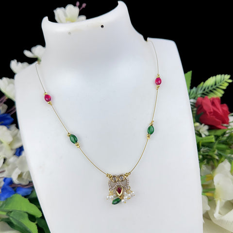 Necklace with gemstones on a white mannequin bust against a floral background