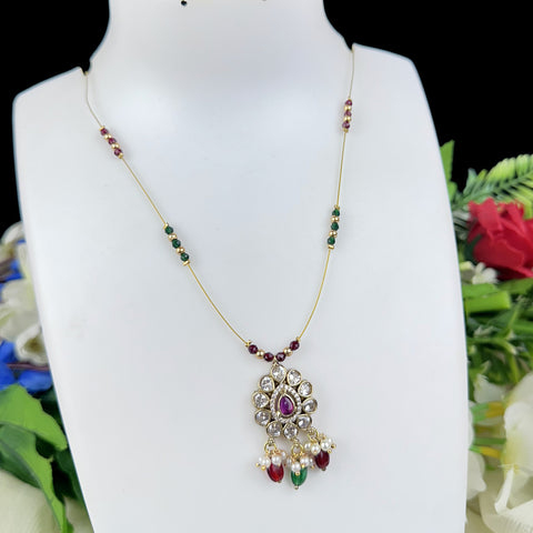 Necklace with a decorative pendant on a mannequin against a floral background