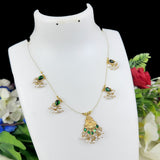 Gold necklace with green stones on a white mannequin bust against a floral background