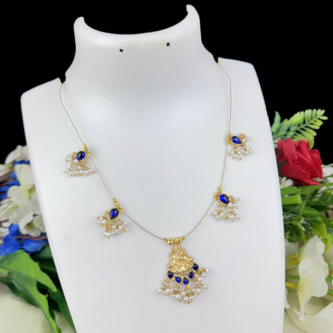 Decorative necklace with blue stones on a white mannequin bust against a floral background