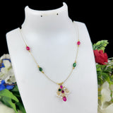 Necklace with colorful beads and a pendant on a white mannequin bust with flowers in the background