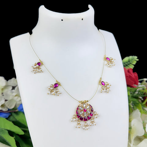 Jewelry set with necklace and earrings on a mannequin bust with flowers in the background