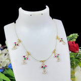 Gold necklace with colorful gemstones on a white mannequin bust against a floral background