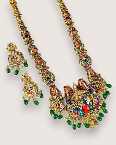 Ornate gold necklace with colorful beads on a white background