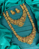 Gold necklace and earrings on a teal fabric background