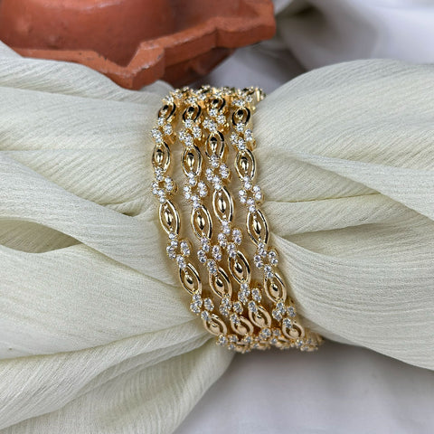 Gold bracelet with diamonds on a textured white surface