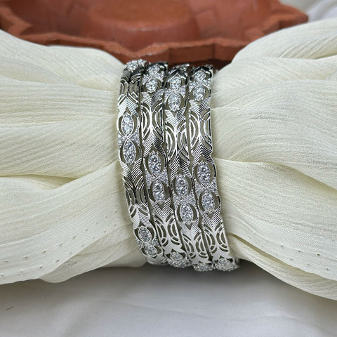 Silver bracelet with gemstones on a white fabric background