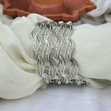 Silver hair comb with rhinestones on a white fabric background