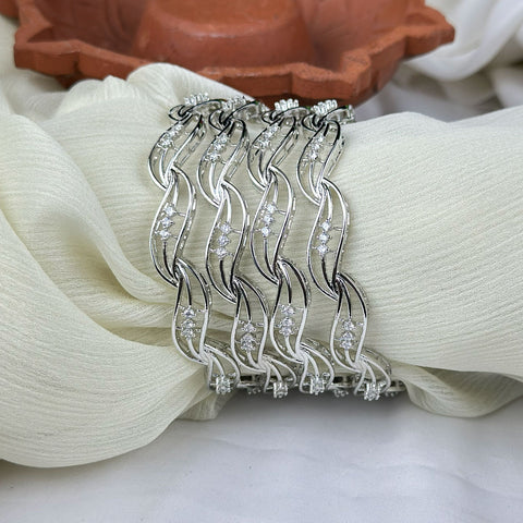 Silver hair comb with rhinestones on a white fabric background