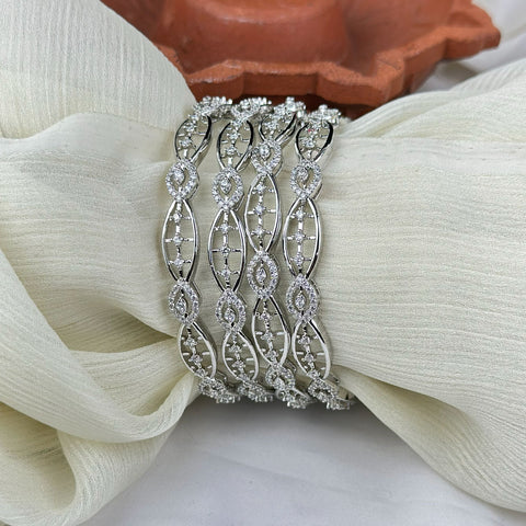 Silver bracelet with diamond accents on a white fabric background