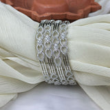 Decorative silver hair comb on a white fabric background