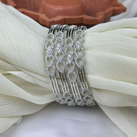 Decorative silver hair comb on a white fabric background